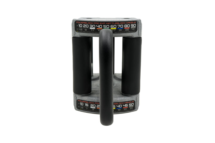 front view of powerblock pro series kettlebell handle showing padded grips and weights in 5 to 10 pound increments